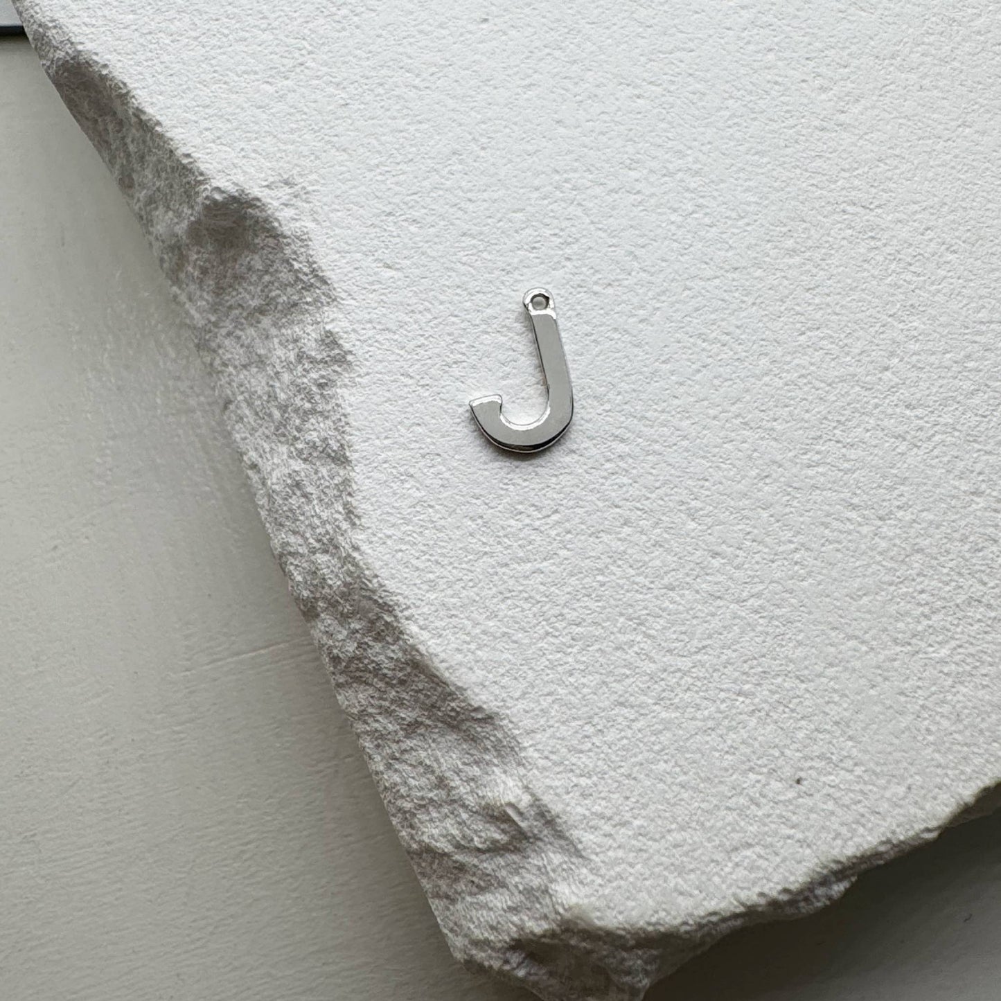 Inicialo pakabukas -  raidelė. Sidabras arba auksas