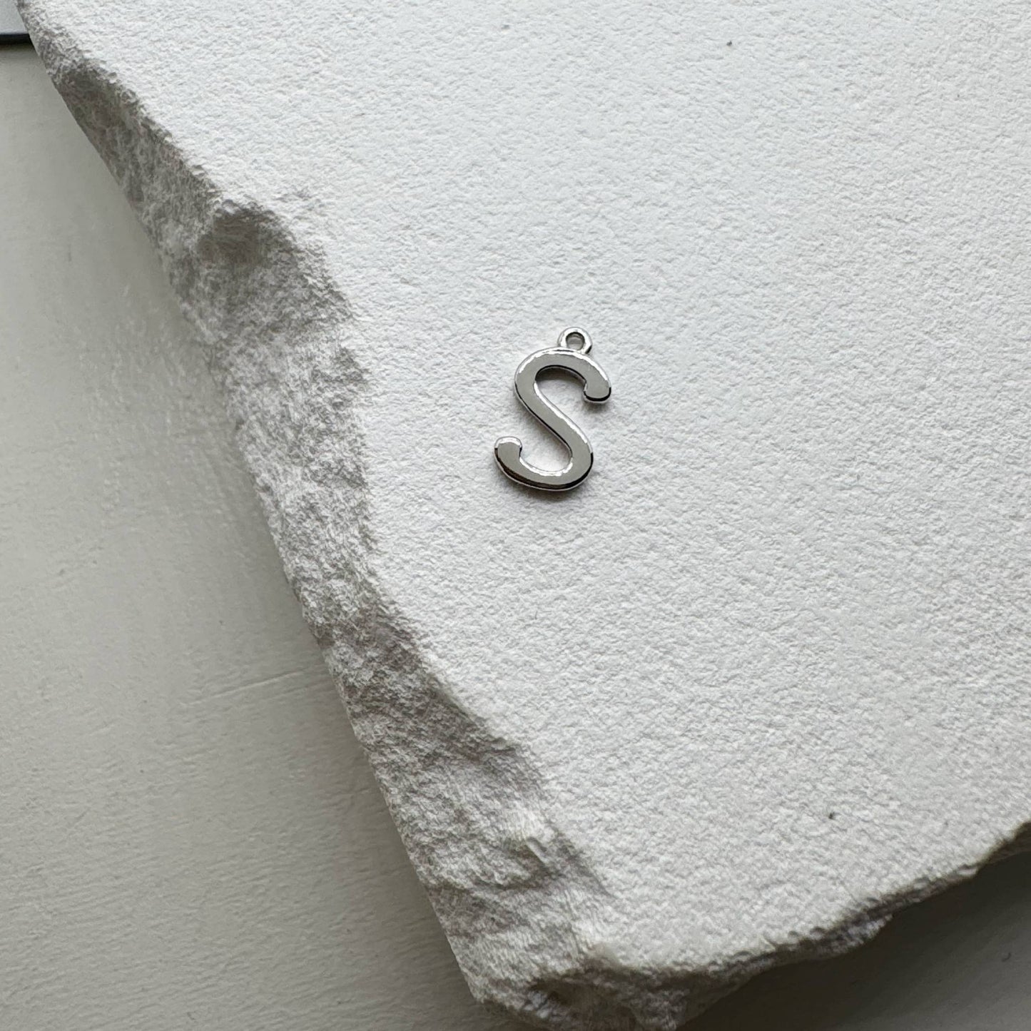 Inicialo pakabukas -  raidelė. Sidabras arba auksas